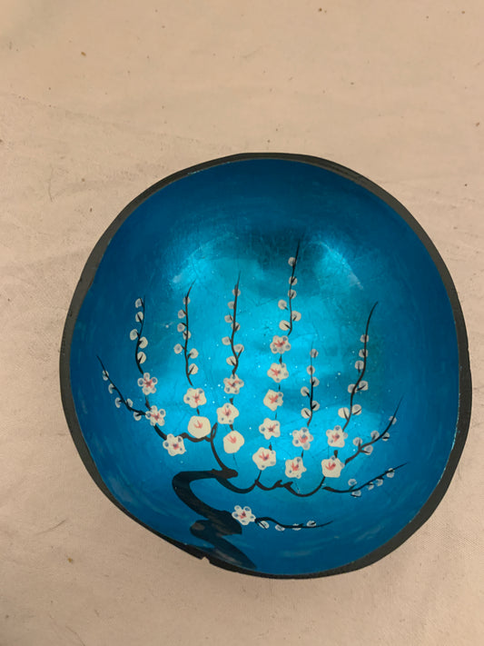 Blue ceramic bowl with floral design on a beige background