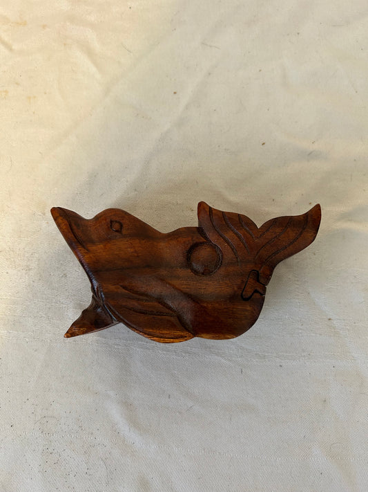 Wooden carvings on a textured beige background