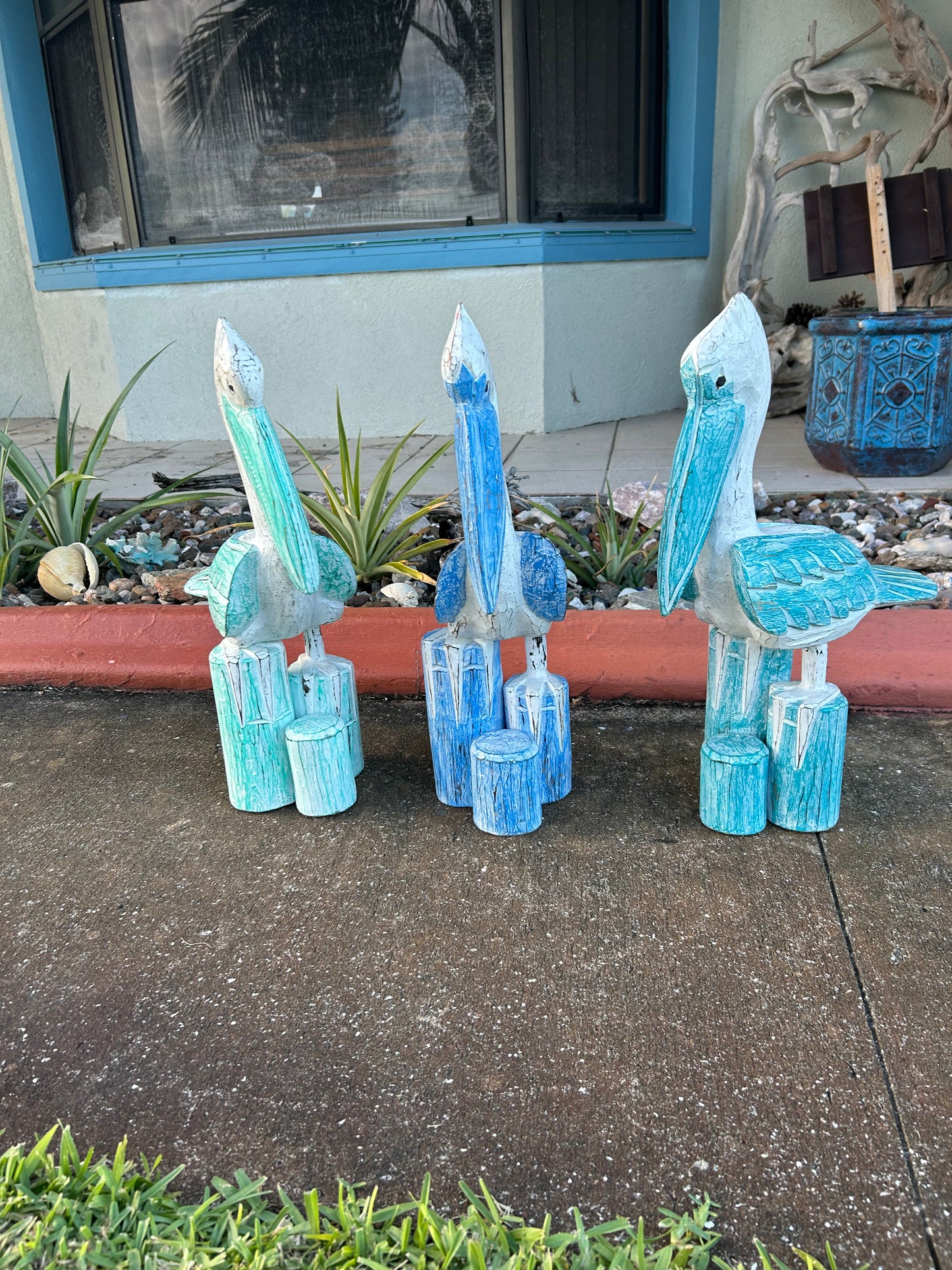 Blue crystal-like sculptures on a sidewalk next to a building