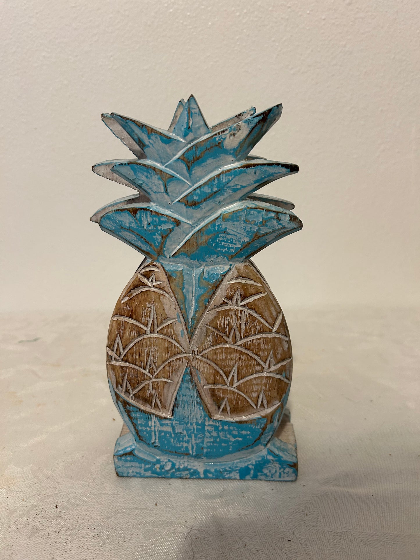Decorative pineapple with blue and brown colors on a light background