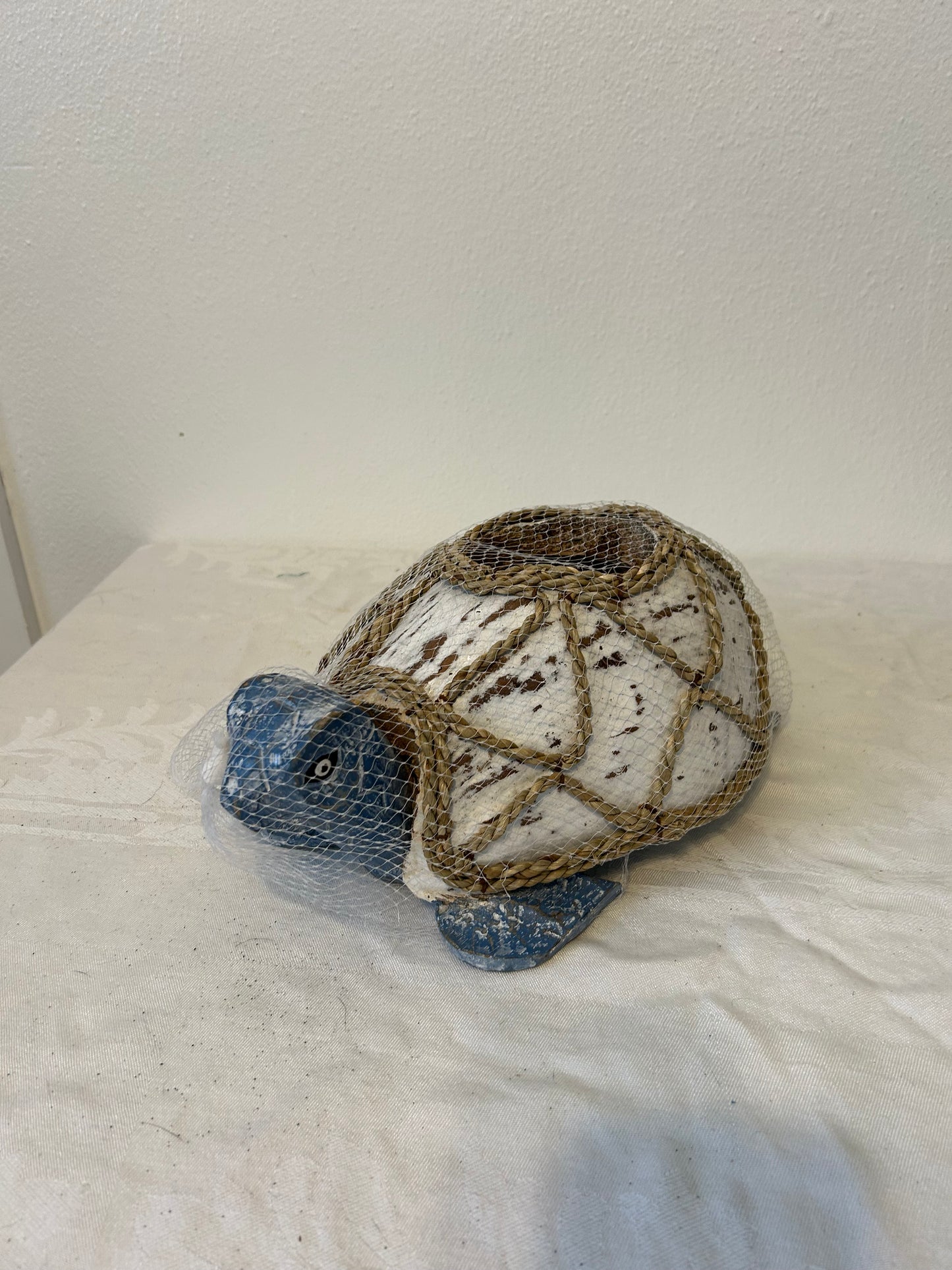 Decorative stone turtle on a textured white surface