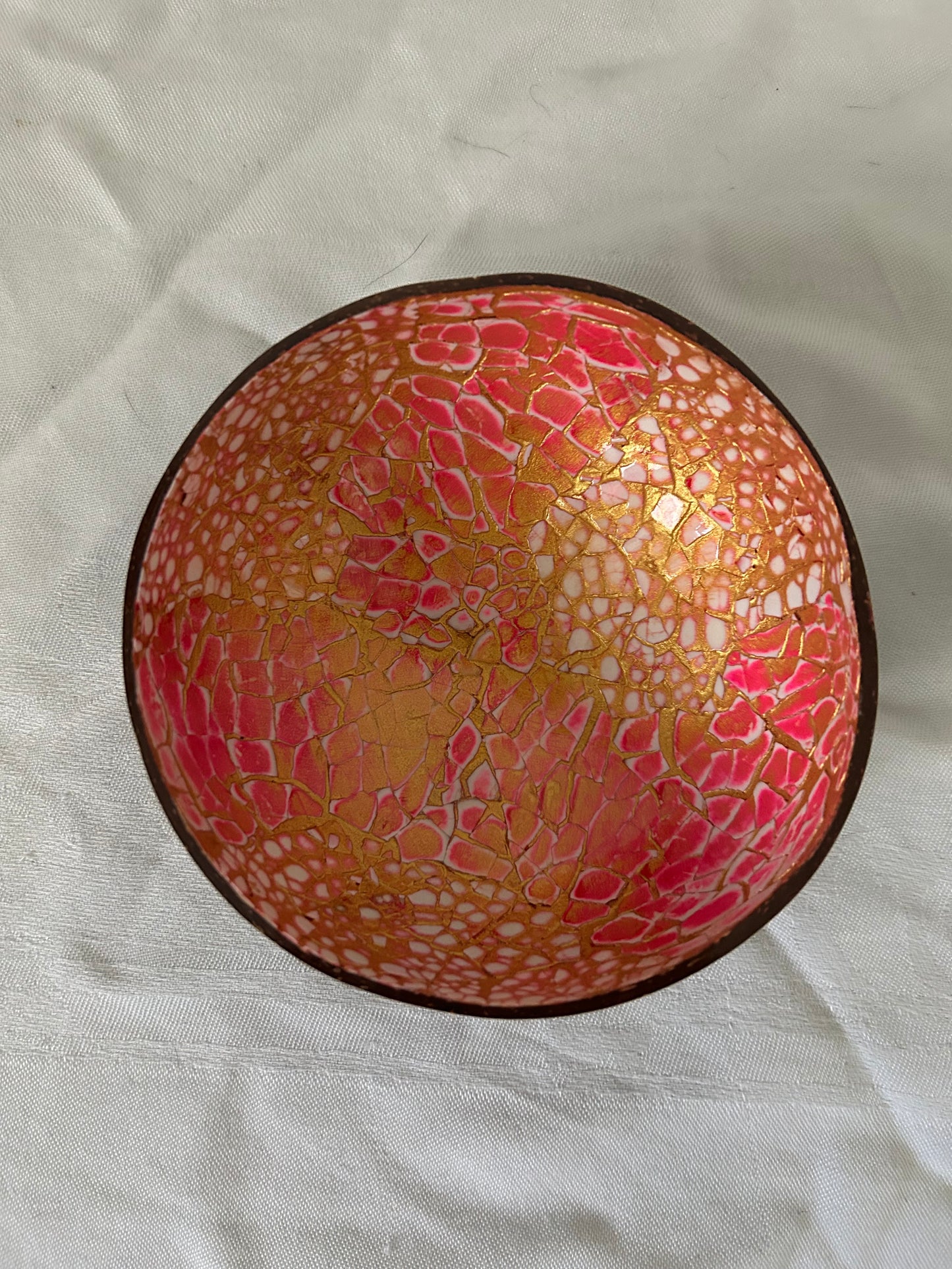 Decorative bowl with a cracked glass design on a light fabric background