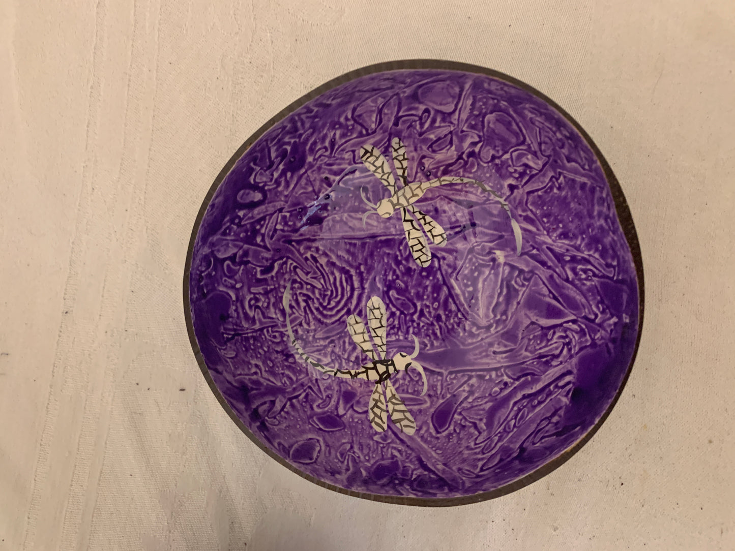 Purple decorative plate with intricate patterns on a beige background