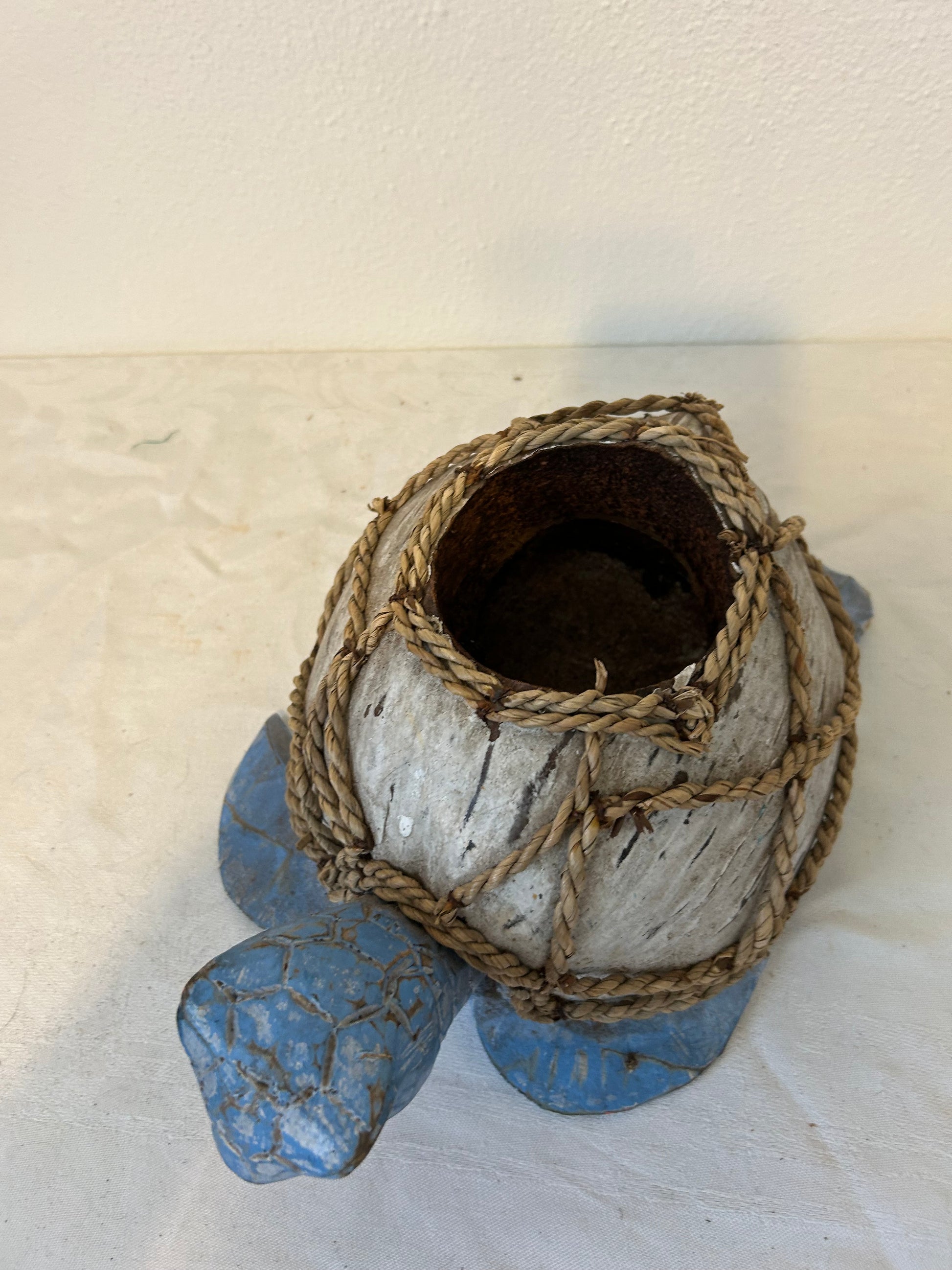 Decorative turtle sculpture with a textured surface on a light background